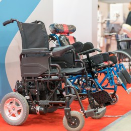 Row of electric wheelchairs lined up in a store. 