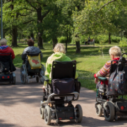 Four Power Wheelchairs in the Park