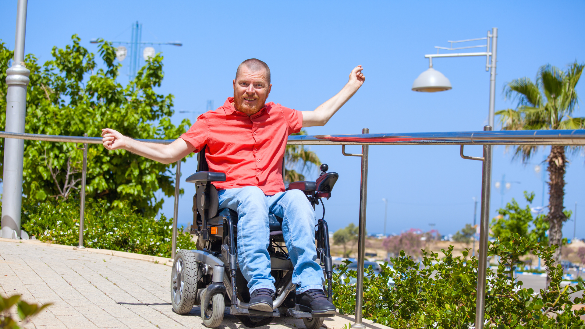 Man riding in wheelchair on sidewalk