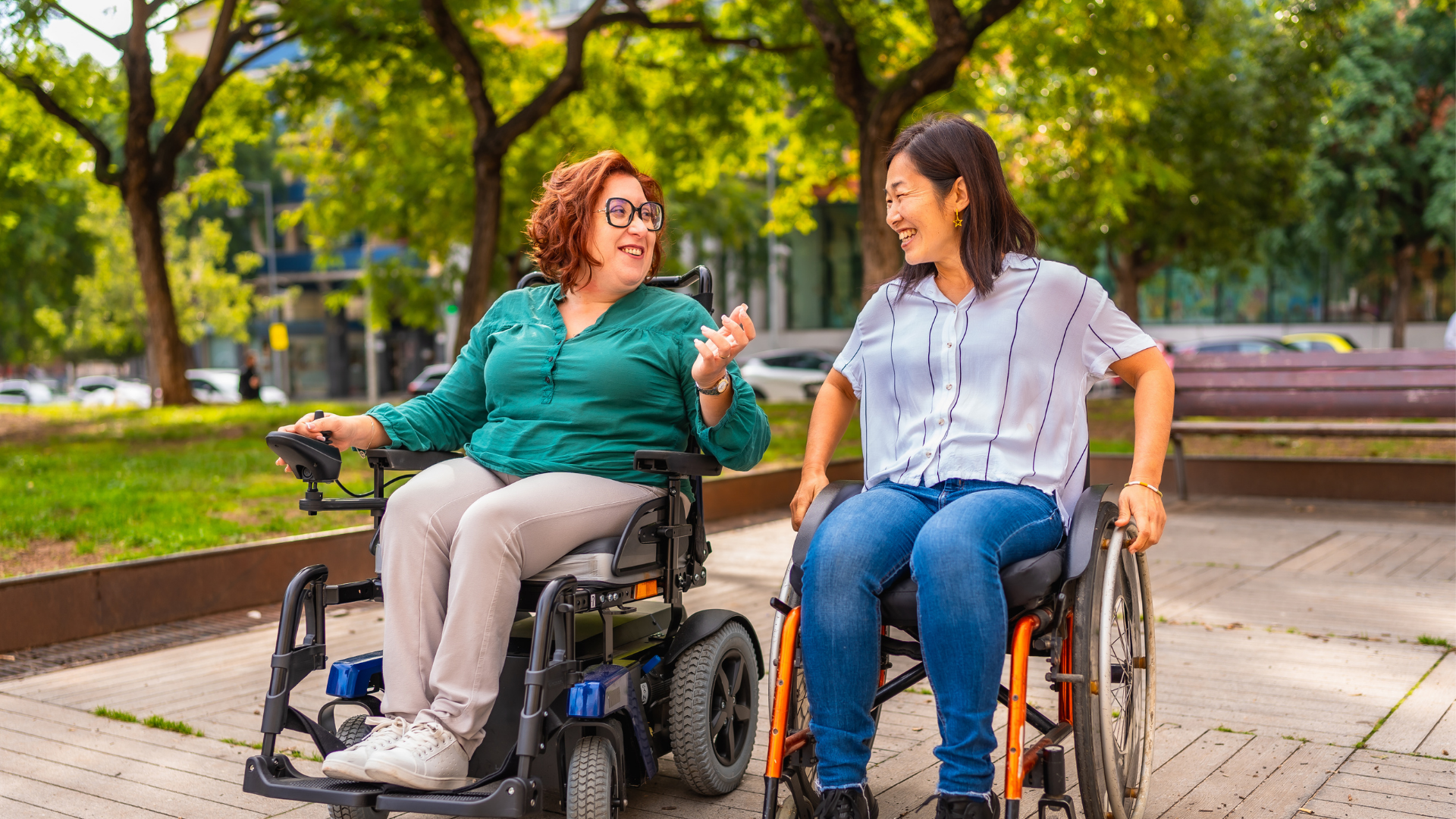 Two friends in wheelchairs talking