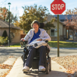 Woman with Power Chair on Sidewalk