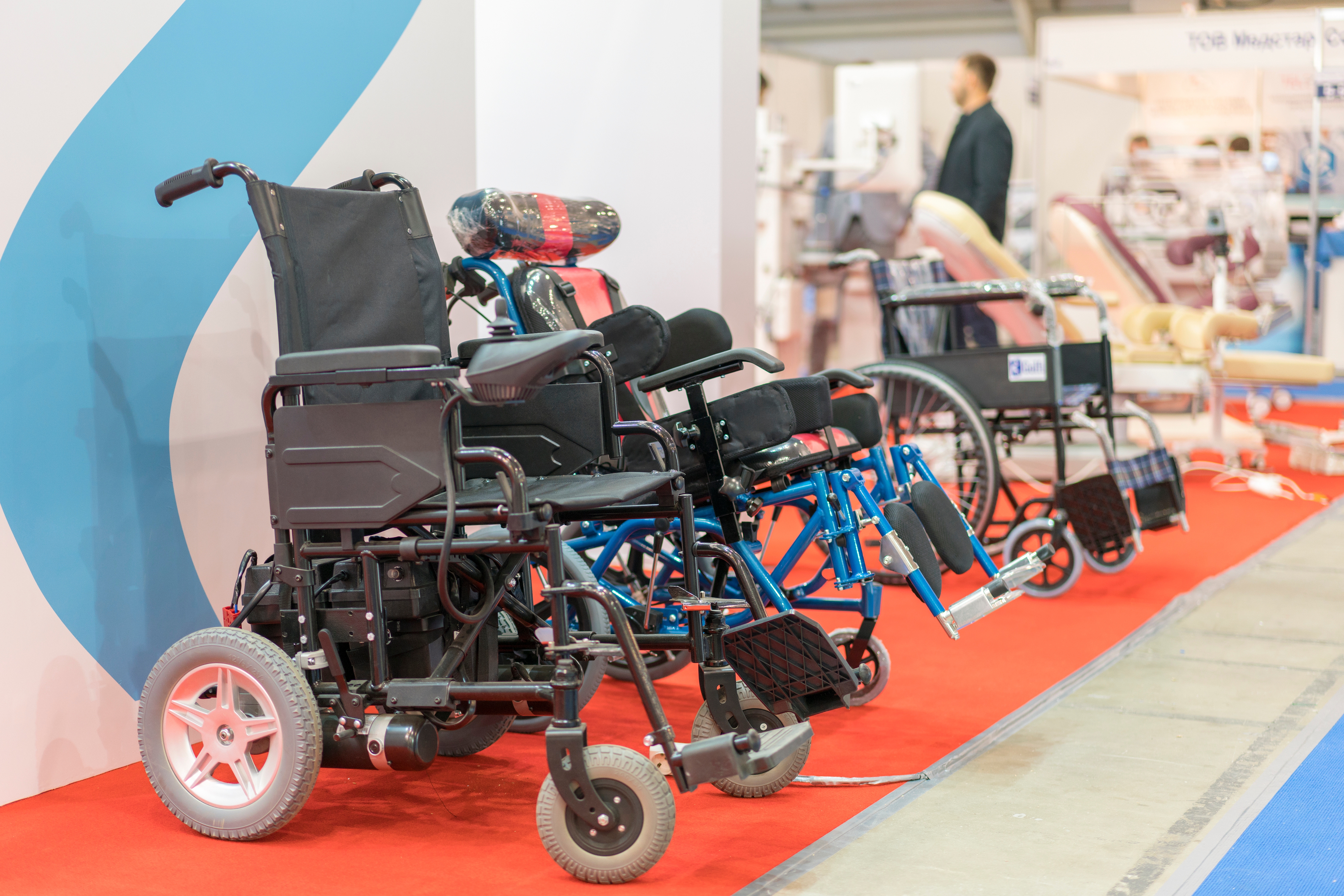 Row of electric wheelchairs lined up in a store. 