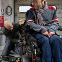Assistive technology professional working on wheelchair