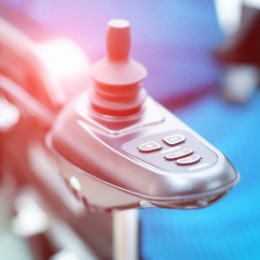 Close up image of an electric wheelchair.