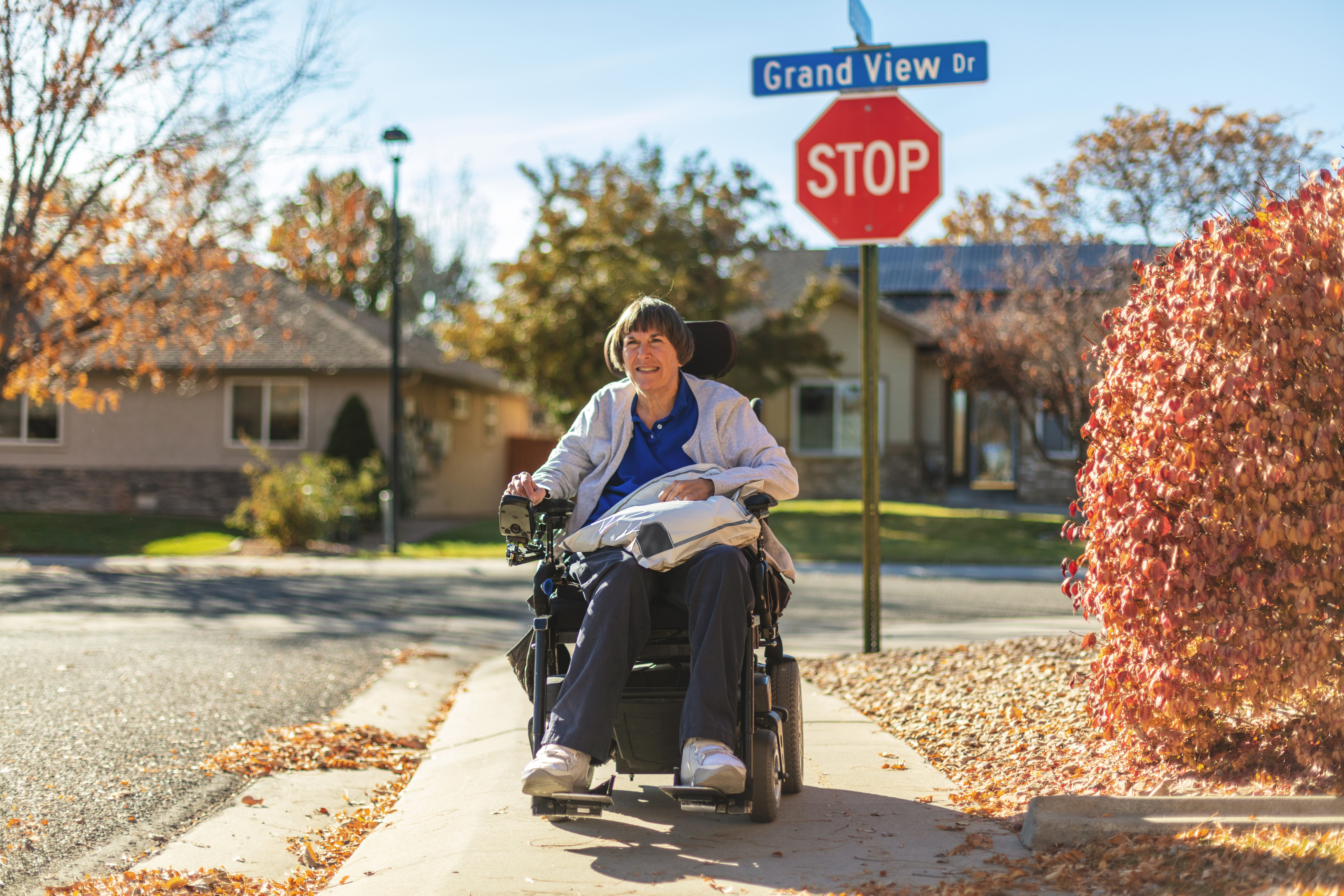 Woman with Power Chair on Sidewalk