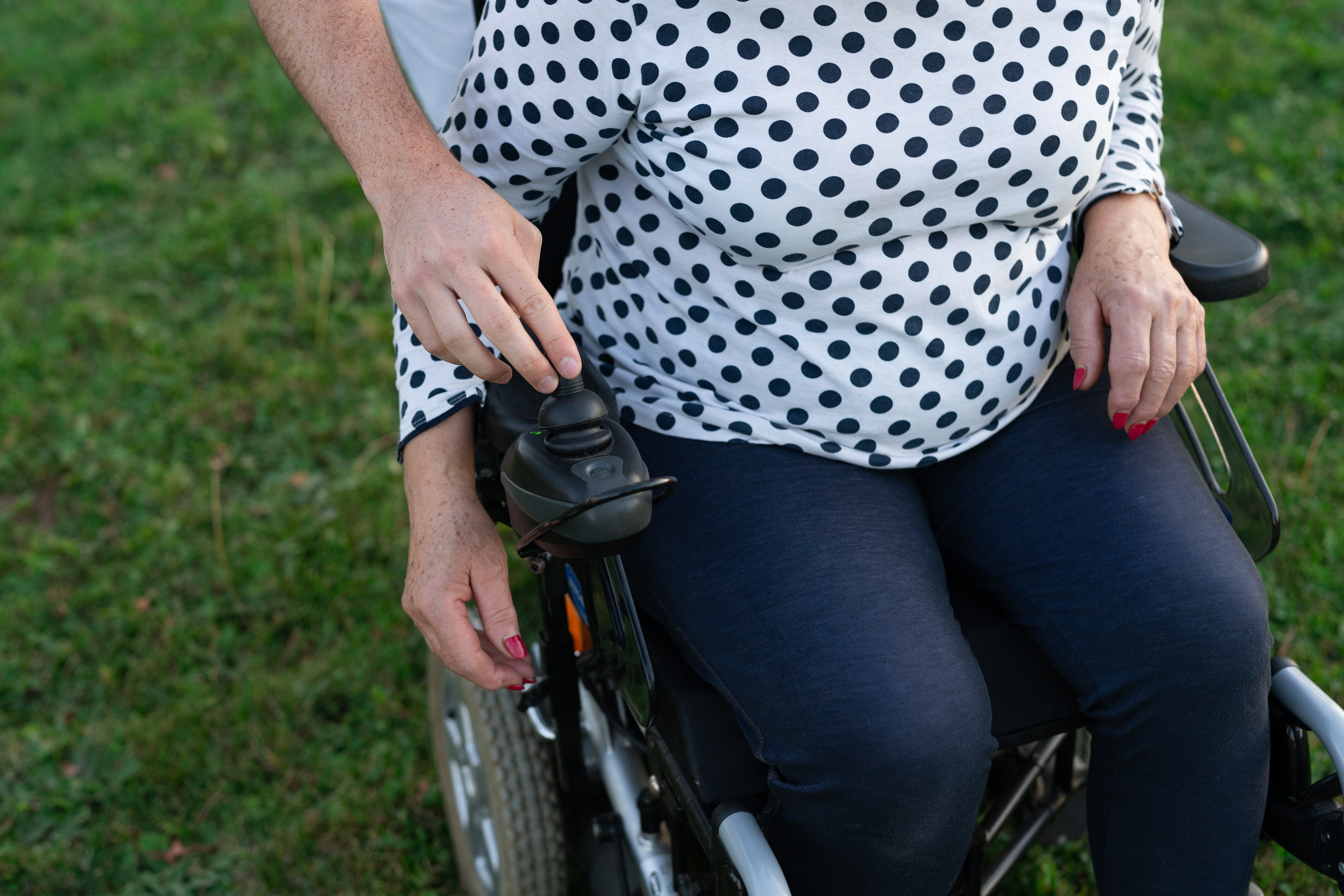 Man Helping Woman With Wheelchair