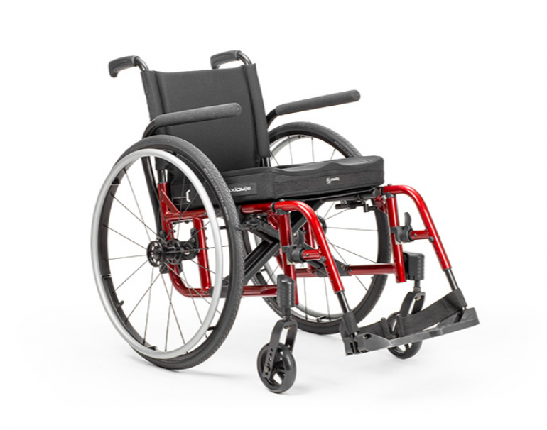 Side view of the Catalyst 5 Manual Wheelchair with red tubing and a black seat.