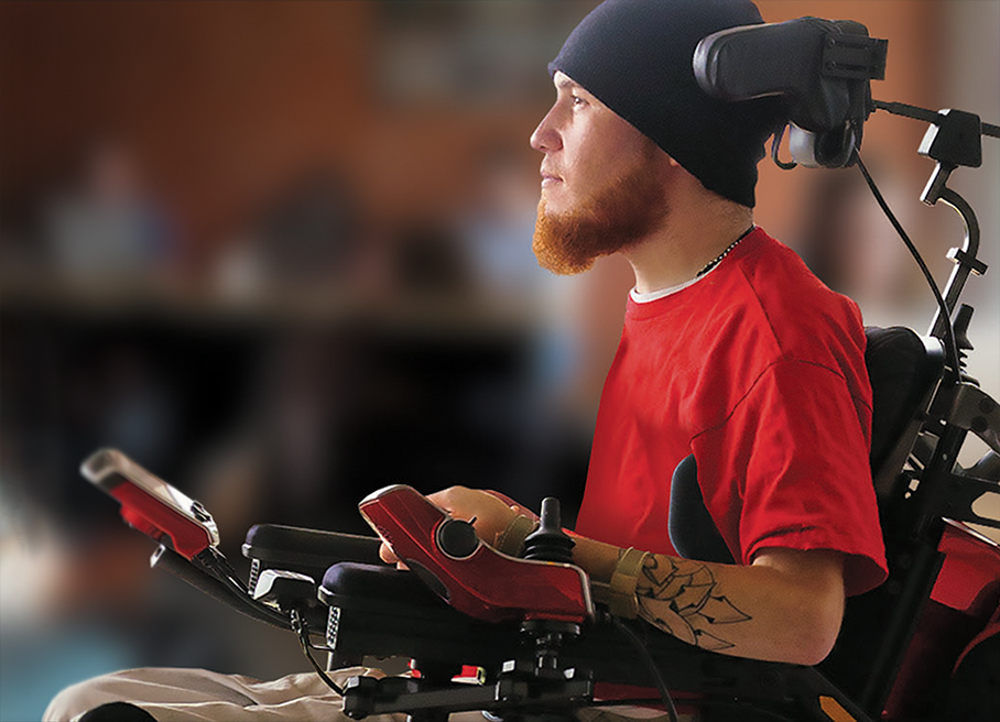 this is an image of a young man using a power wheelchair with high-end electronics