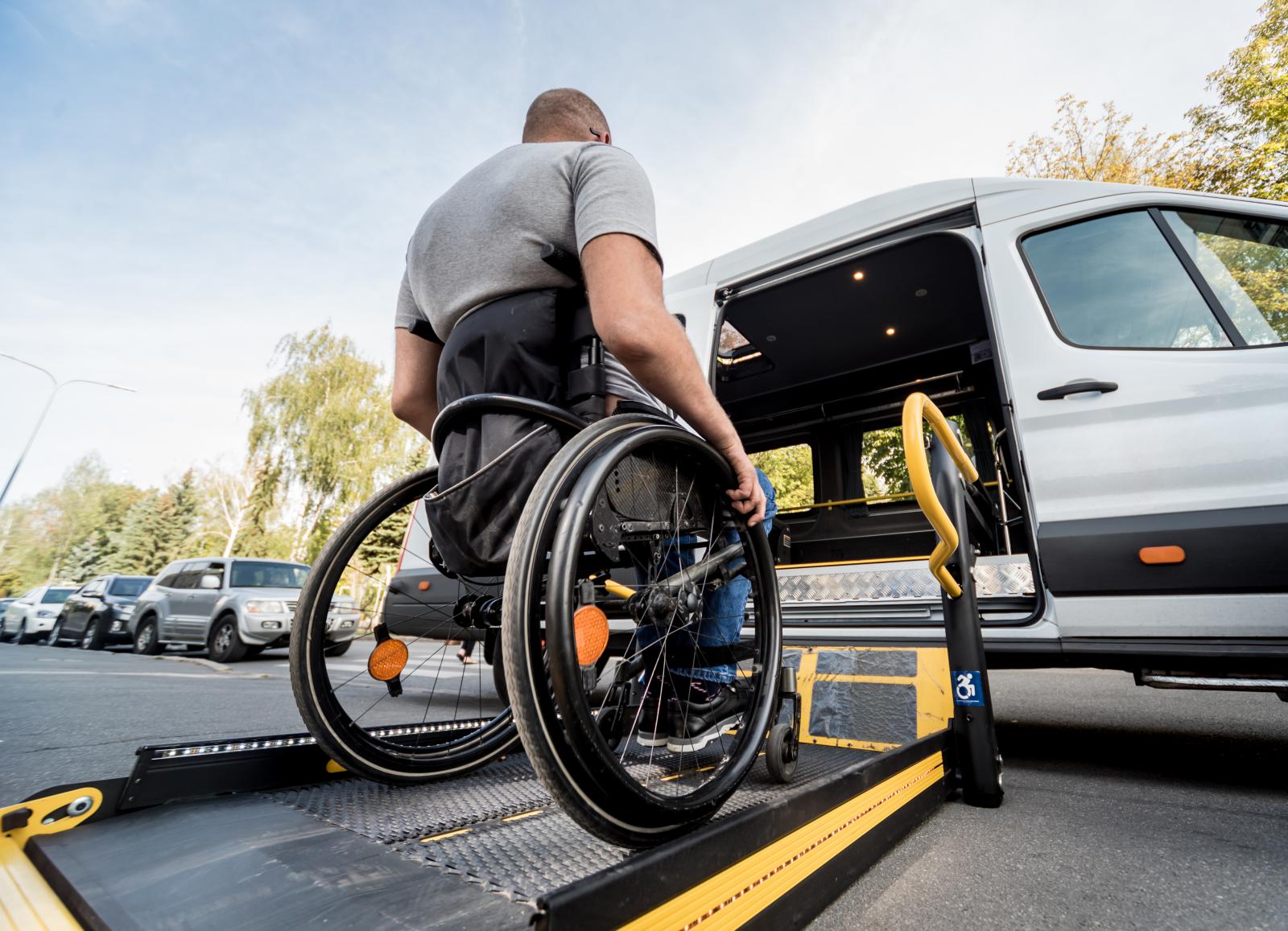 Man getting into a wheelchair-accessible vehicle in his wheelchair. 